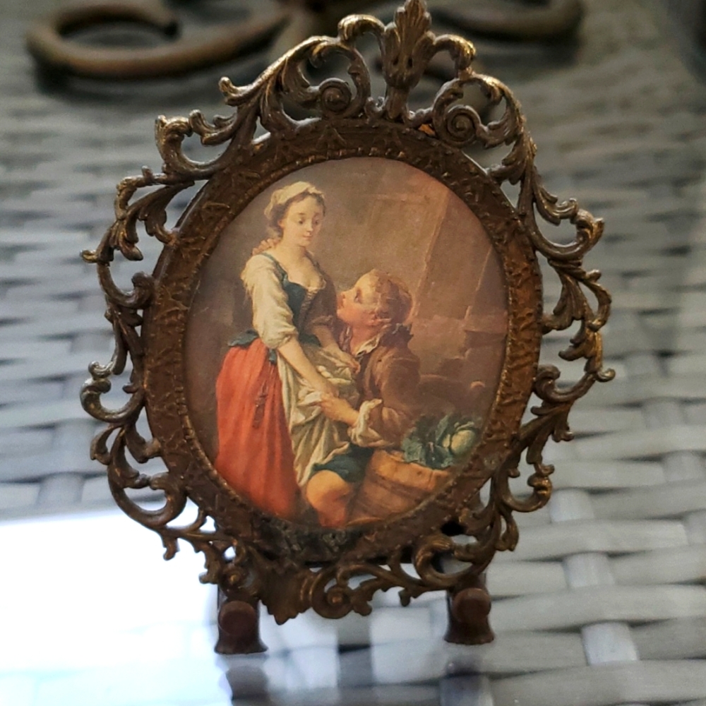 Miniature vintage portrait in metal frame.